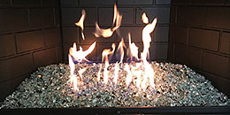 Silver Reflective Nugget fire glass installed in an indoor fireplace by Diamond Fire Glass 